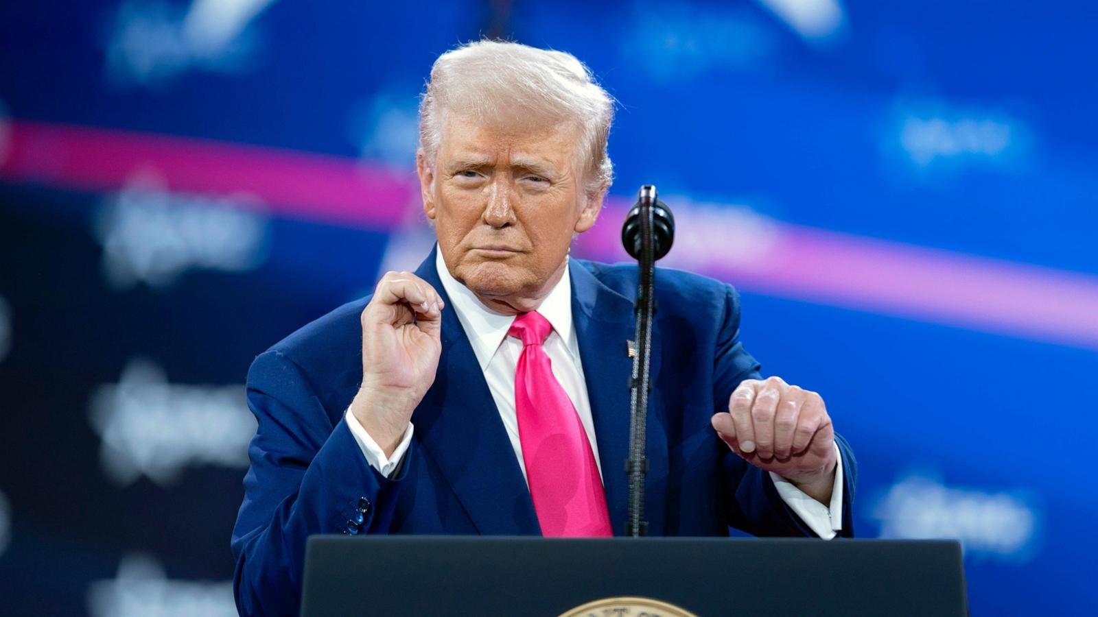 Trump revels in mass federal firings and jeers at Biden before adoring conservative crowd